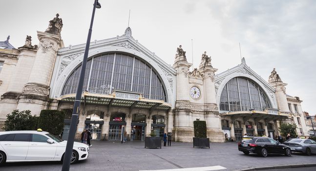 Tours, France - February 8, 2020: street atmosphere in front of the Tours train station in the city center where passengers are waiting and taxis are driving on a winter day