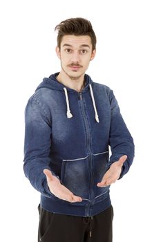 friendly young man pointing to his side and looking into the camera. isolated on white background