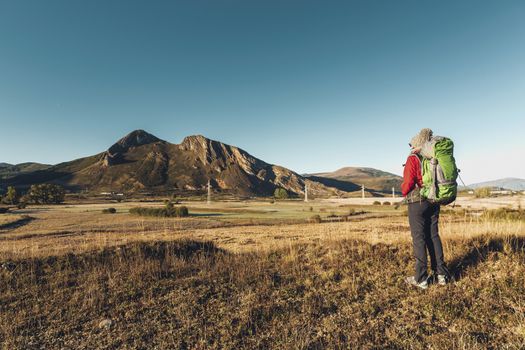 Rear view of a woman with a backpack enjoying the view