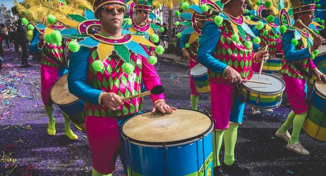 Loule, Portugal - February 25, 2020: percussionists parading in the street accompanying dancers in the parade of the traditional carnival of Loule city on a February day