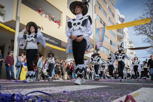 Loule, Portugal - February 25, 2020: dancers parading in the street in front of the public in the parade of the traditional carnival of Loule city on a February day