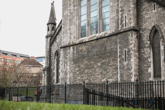 Dublin, Ireland - February 13, 2019: Street atmosphere and architecture of St Patrick's Cathedral that people visit on a winter day