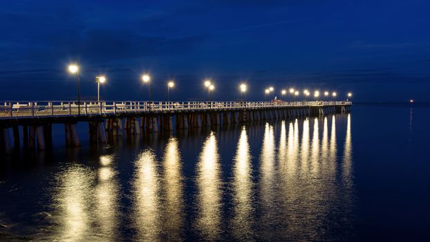 Panoramic view of wooden pier in Gdynia Orlowo in Poland at night