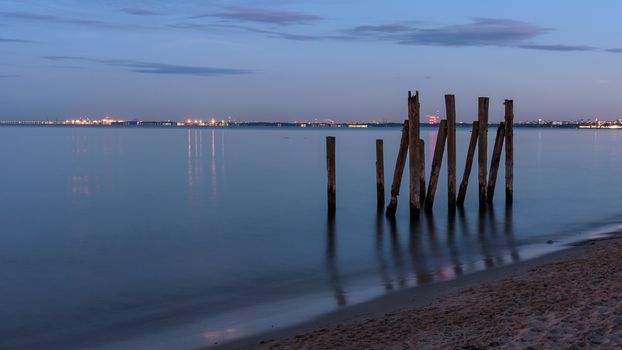 Wooden piles in the Gulf of Gdansk at the beach in Gdynia Orlowo in Poland at dusk
