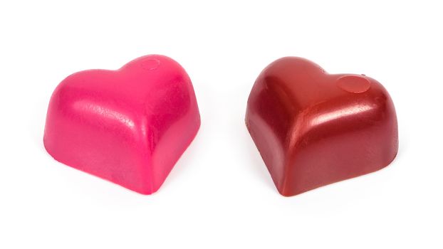 Two heart shaped chocolates in a row isolated on white background with clipping path