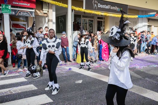 Loule, Portugal - February 25, 2020: dancers parading in the street in front of the public in the parade of the traditional carnival of Loule city on a February day