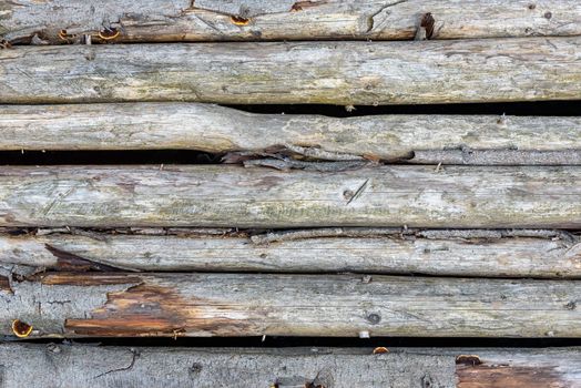 Old wooden wall made of logs as a background