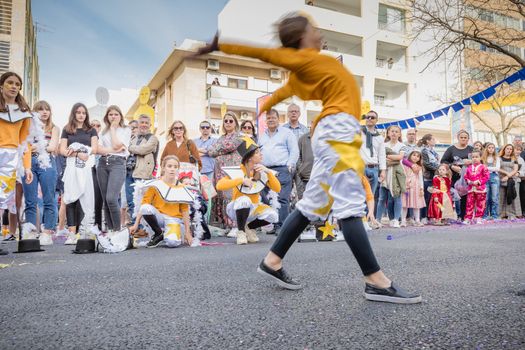 Loule, Portugal - February 25, 2020: dancers parading in the street in front of the public in the parade of the traditional carnival of Loule city on a February day