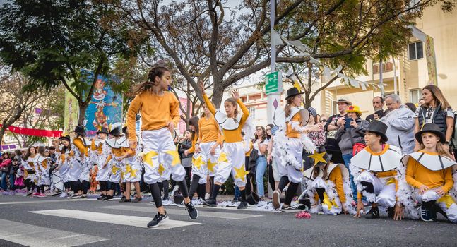 Loule, Portugal - February 25, 2020: dancers parading in the street in front of the public in the parade of the traditional carnival of Loule city on a February day