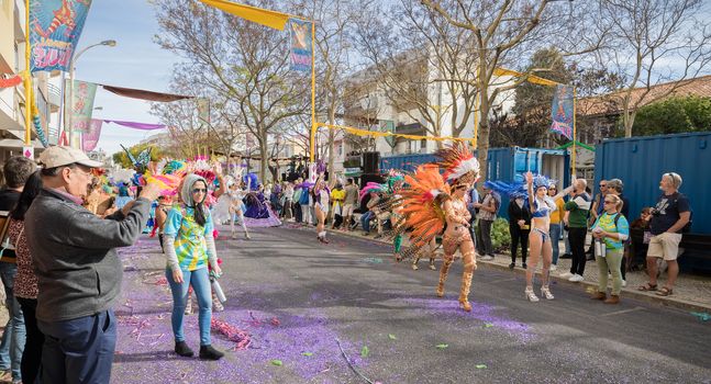 Loule, Portugal - February 25, 2020: dancers parading in the street in front of the public in the parade of the traditional carnival of Loule city on a February day