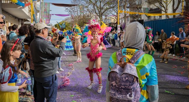 Loule, Portugal - February 25, 2020: dancers parading in the street in front of the public in the parade of the traditional carnival of Loule city on a February day