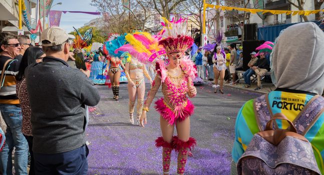 Loule, Portugal - February 25, 2020: dancers parading in the street in front of the public in the parade of the traditional carnival of Loule city on a February day