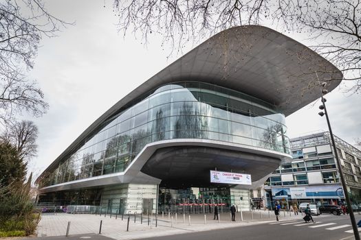 Tours, France - February 8, 2020: people passing the city convention center on a winter day in bad weather. Building designed by Jean Nouvel with Yves Brunier, landscaper