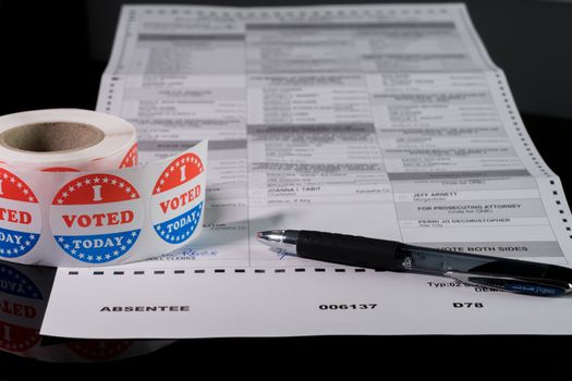 Morgantown, WV - 21 May 2020: West Virginia state primary election absent ballot form with focus on the word Absentee and on I Voted Today sticker