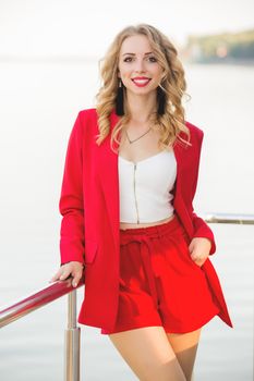 Business attractive woman in city wear red business suit, bussinestyle for women