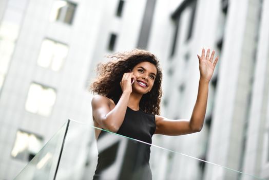 Happy smiling afroamerican woman have a nice conversation at street.