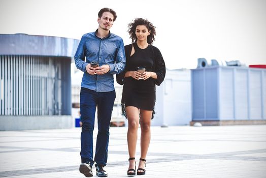 Modern business man and woman wearing smart casual clothes in the city. Urban lifestyle.