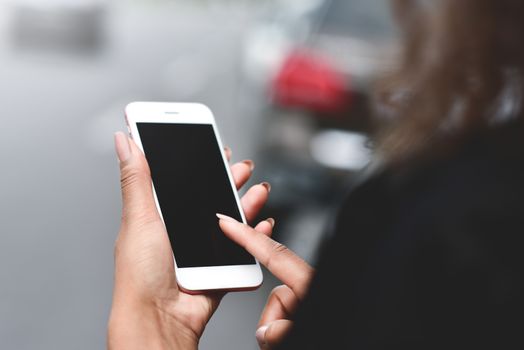 Cropped image of woman's hands holding smart phone with blank copy space screen for your text message or promotional content, female chatting in network on cell telephone.