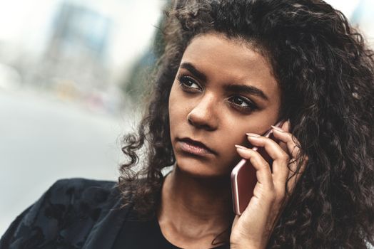 Sad woman walking and writing or reading sms messages