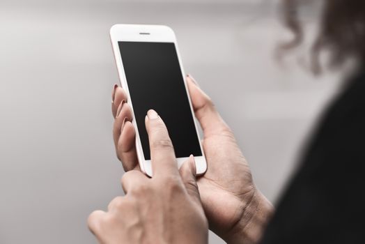 Cropped image of woman's hands holding smart phone with blank copy space screen for your text message or promotional content, female chatting in network on cell telephone.