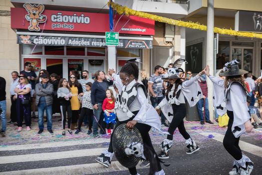 Loule, Portugal - February 25, 2020: dancers parading in the street in front of the public in the parade of the traditional carnival of Loule city on a February day