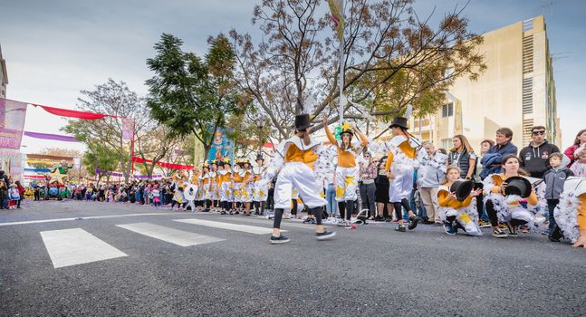 Loule, Portugal - February 25, 2020: dancers parading in the street in front of the public in the parade of the traditional carnival of Loule city on a February day