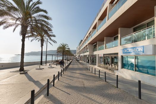 Sesimbra, Portugal - February 20, 2020: View of the city center of Sesimbra by the sea where people are walking on a winter day