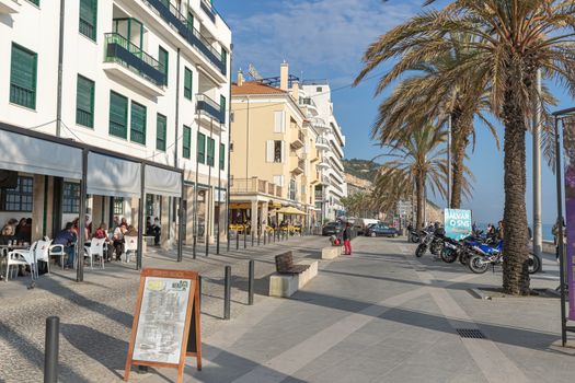 Sesimbra, Portugal - February 20, 2020: View of the city center of Sesimbra by the sea where people are walking on a winter day