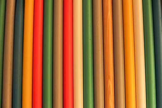 Close up of colored wooden drum sticks arranged in a row