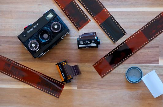 The Germany Film camera Rollei 35T with Kodak film and Lomography film and Film sheet on Wooden Background