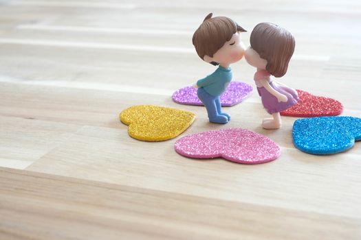 The Miniature Couple dolls Boy and Girl Romantic Kiss with Heart around the Ground  for Background for valentine's Day Concept