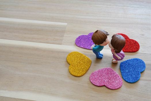 The Miniature Couple dolls Boy and Girl Romantic Kiss with Heart around the Ground  for Background for valentine's Day Concept