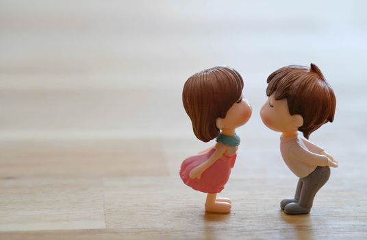 The Miniature Couple dolls Boy and Girl Romantic Kiss with Heart around the Ground  for Background for valentine's Day Concept