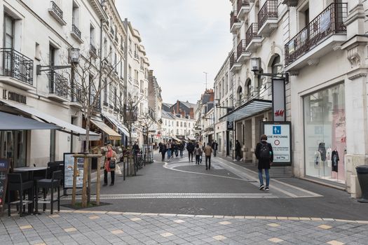 Tours, France - February 8, 2020: Street ambiance and architecture in a pedestrian street in the historic city center where people walk on a winter day on a winter day