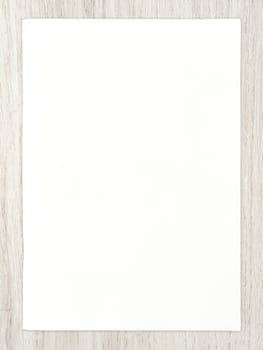 White paper sheet on wood for business  background.