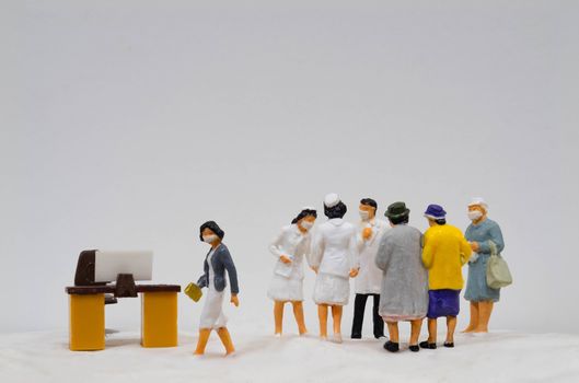 Miniature figure doll Group of Doctor Nurse and Patient wearing mask to Protect Covid-19 or Coronavirus in Hospital They are Talking consulting to other