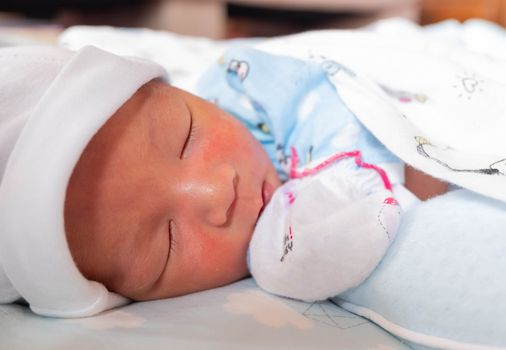 The Sleeping cute New Born Baby infant on the bed