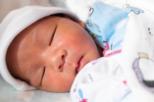 The Sleeping cute New Born Baby infant on the bed