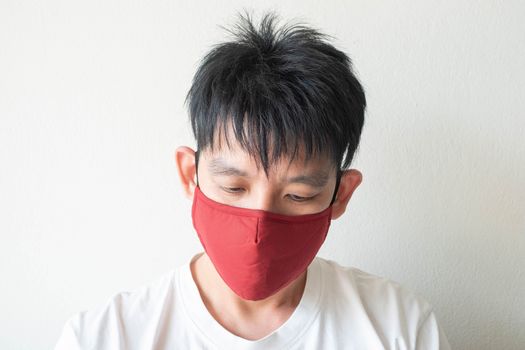 The Face of Asian Man Wearing Face Mask to protect himself from Coronavirus Covid-19 and pm 2.5 Pollution Isolate on White Background