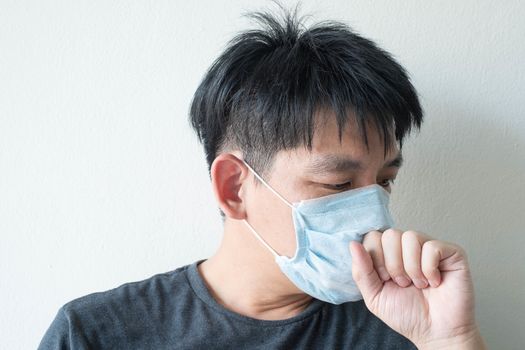 The Face of Sick Asian Chinese Man Wearing Face Mask feeling sick headache and  cough because of  Coronavirus Covid-19  Isolate on White Background