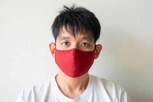 The Face of Asian Man Wearing Face Mask to protect himself from Coronavirus Covid-19 and pm 2.5 Pollution Isolate on White Background