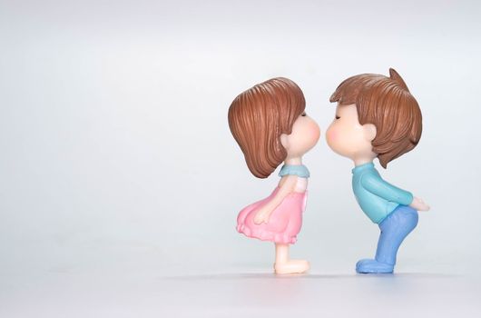 The Miniature doll of couple boy and girl kiss  isolate on White background