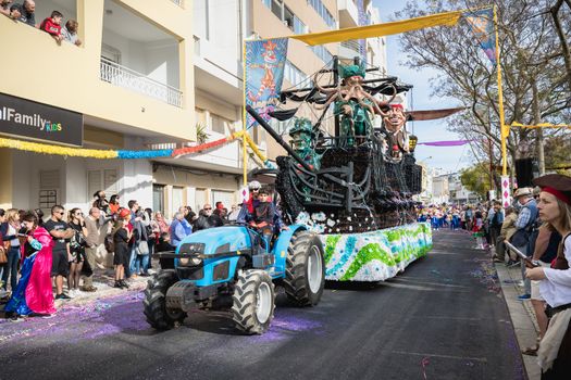 Loule, Portugal - February 25, 2020: Pirate ship float parading in the street in front of the public in the parade of the traditional carnival of Loule city on a February day