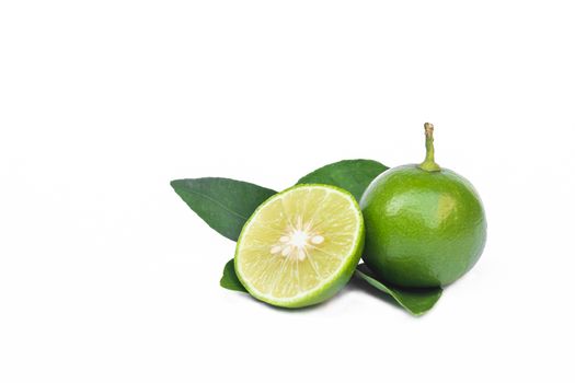 Green lemons with half and leaf isolated on white background