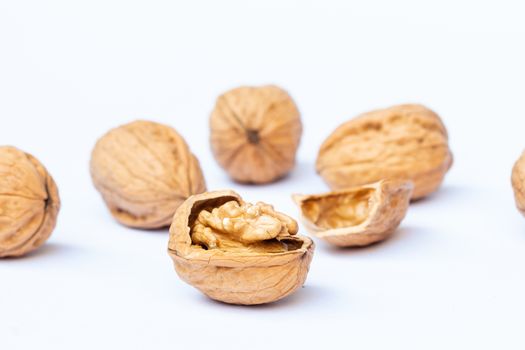 still life with Walnut kernels and whole walnuts on rustic table