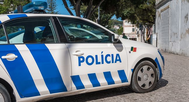 Setubal, Portugal - August 8, 2018: Portuguese police car parked in the historic city center on a summer day.