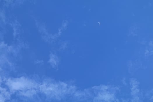 Beautiful blue and small moon on sky with clouds for background and bright lighting clear on Summer