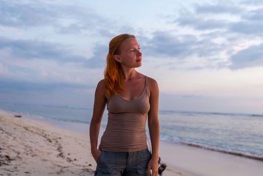 Young woman enjoying sunset view at tropical island beach