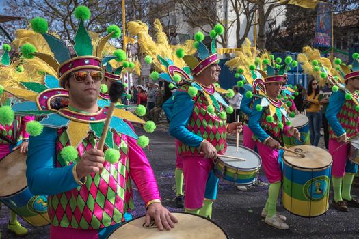 Loule, Portugal - February 25, 2020: percussionists parading in the street accompanying dancers in the parade of the traditional carnival of Loule city on a February day