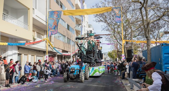 Loule, Portugal - February 25, 2020: Pirate ship float parading in the street in front of the public in the parade of the traditional carnival of Loule city on a February day